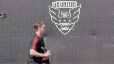 Soccer Players Running In Front Of D.C. United Logo GIF