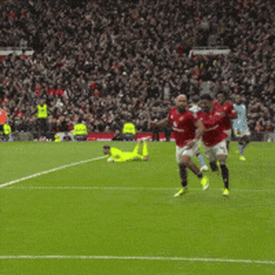 Soccer Players Running On Field In Front Of Crowd GIF