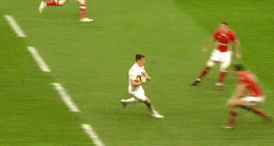 Soccer Players Running on Field