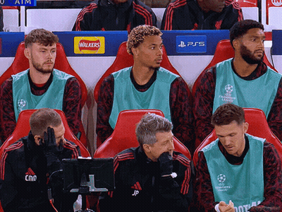 Soccer Players Sitting In Locker Room With Walkers And PS5 Logos GIF
