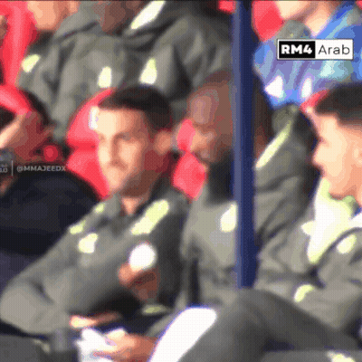 Soccer Players Sitting In Stadium With Sign Saying RM4 Ara GIF