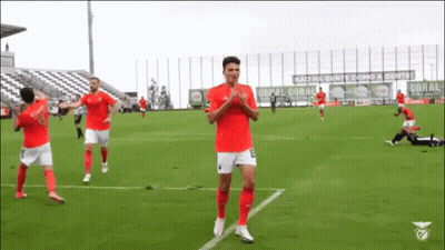 Soccer Players with Coral Banner