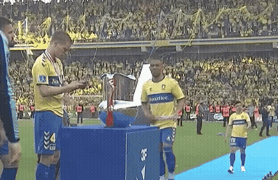 Soccer Players With Trophy Number 4 GIF