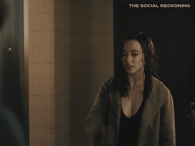 Social Reckoning Poster Woman Standing In Front Of Door GIF