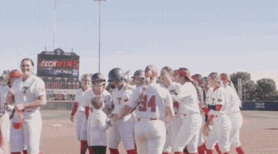 Softball Players In Front Of Tech Wins Sign GIF