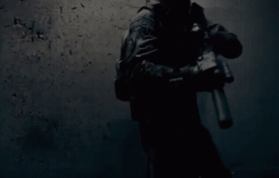 Soldier Holding Gun in Dark Room