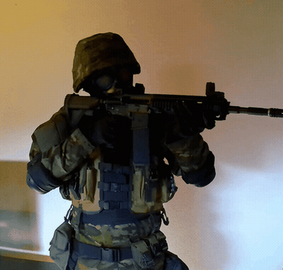 Soldier Holding Gun Wearing Gas Mask GIF