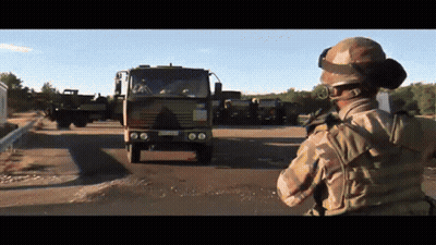 Soldier In Front Of Military Truck With LC License Plate GIF