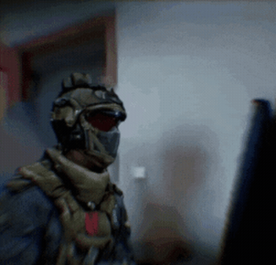 Soldier In Helmet And Mask Looking At Computer Monitor GIF