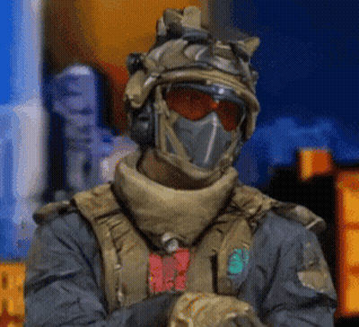 Soldier in Helmet and Mask Standing in Front of Building