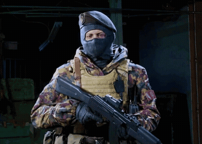 Soldier In Mask And Beret Holding Rifle GIF