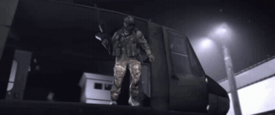 Soldier Riding Motorcycle On Top Of Vehicle GIF