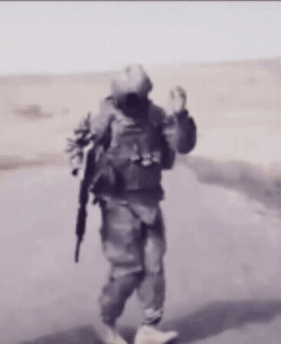 Soldier Walking Down Road With Gun GIF