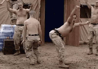 Soldiers Dancing In Dirt Near Water Bottles GIF