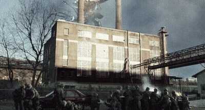 Soldiers Gathered In Front Of Burning Building GIF