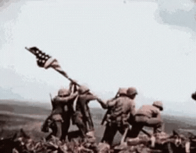 Soldiers Holding American Flag On Mountain GIF