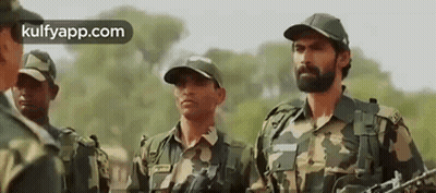 Soldiers Holding Guns In Field GIF
