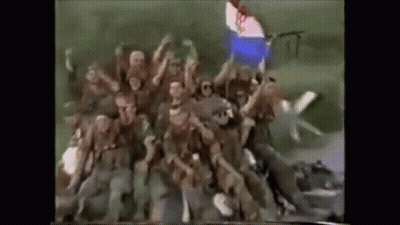 Soldiers In Field With Hands Up GIF