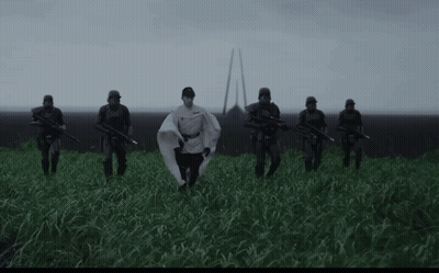 Soldiers in Field With Man in White Cape