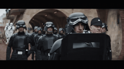Soldiers In Helmets And Goggles Walking Down Street GIF