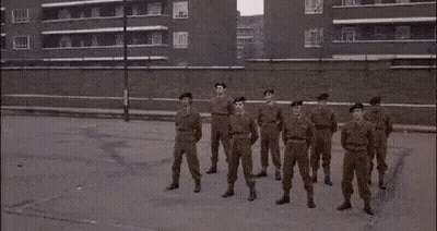 Soldiers In Military Uniforms Standing GIF