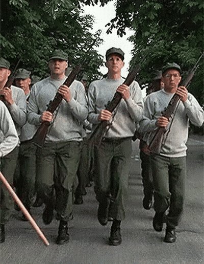 Soldiers Marching Down Street Holding Guns GIF