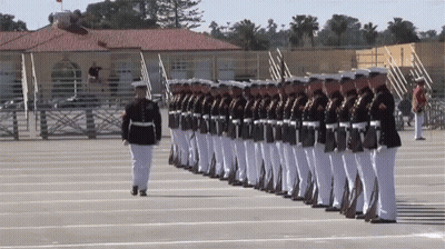 Soldiers Marching In A Row With Man In Front GIF