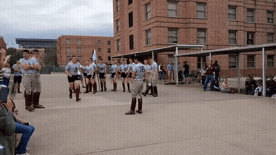 Soldiers Marching In Front Of Building Number 16 GIF