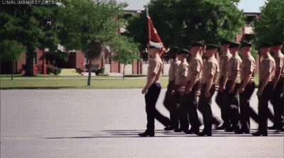 Soldiers Marching In Line With Flag GIF