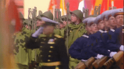 Soldiers Marching In Line With Man In Black Uniform GIF