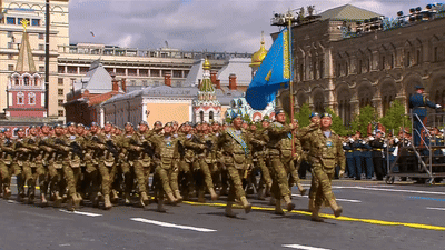 Soldiers Marching With Blue Flag GIF