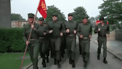 Soldiers Marching With Stop Sign GIF