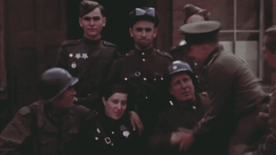 Soldiers Posing With One In Blue Helmet GIF