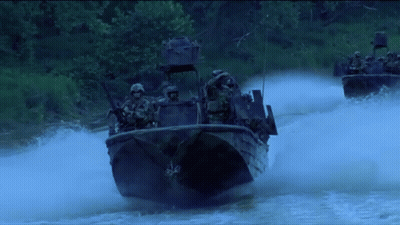 Soldiers Riding Boats Down River GIF