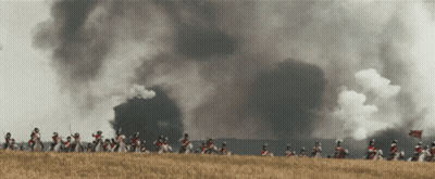 Soldiers Riding Horses With Smoke From Building GIF