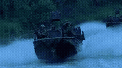 Soldiers Riding In Boat Down River At Night GIF