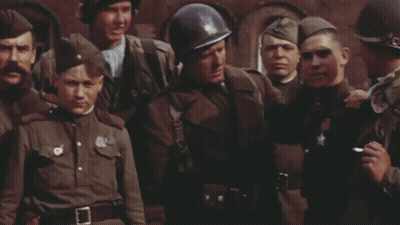 Soldiers Standing Around Man With Star on Chest