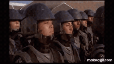 Soldiers Standing In A Row With Helmets And Armor GIF