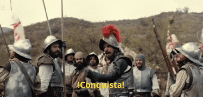 Soldiers Standing In Front Of Conquista Sign GIF