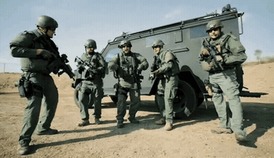 Soldiers Standing In Front Of Military Vehicle GIF