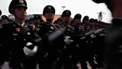 Soldiers Standing In Front Of Red Flag GIF