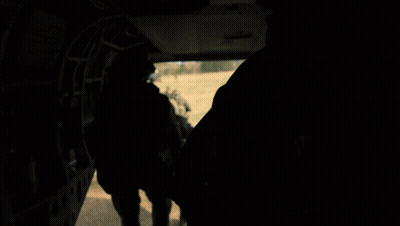Soldiers Walking Across Field With Helicopter GIF