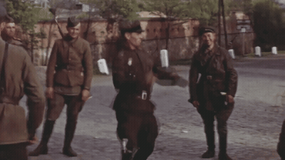 Soldiers Walking Down Street With Letter D On Uniform GIF