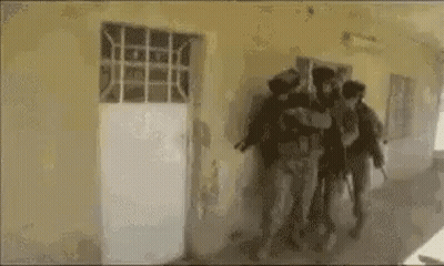 Soldiers Walking Through Hallway GIF