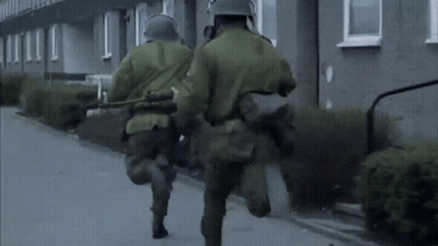 Soldiers Wearing Gas Masks And Helmets Walking GIF