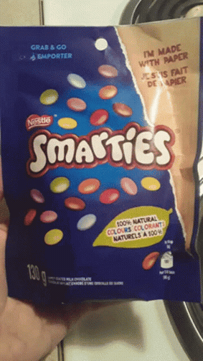 Someone Holding Nestle Smarties Bag GIF