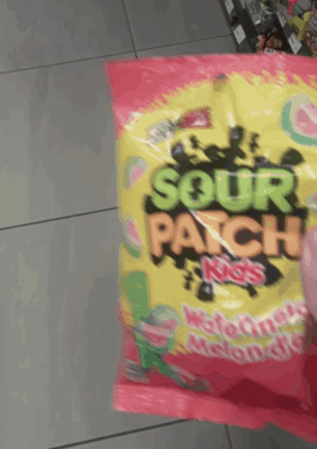 Someone Is Holding A Bag Of Sour Patch Kids Watermelon Flavored Candy GIF