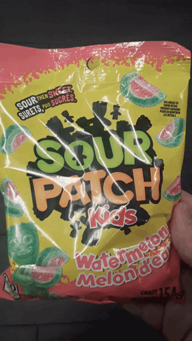 Someone Is Holding A Bag Of Sour Patch Kids Watermelon Melon Dew Candy GIF
