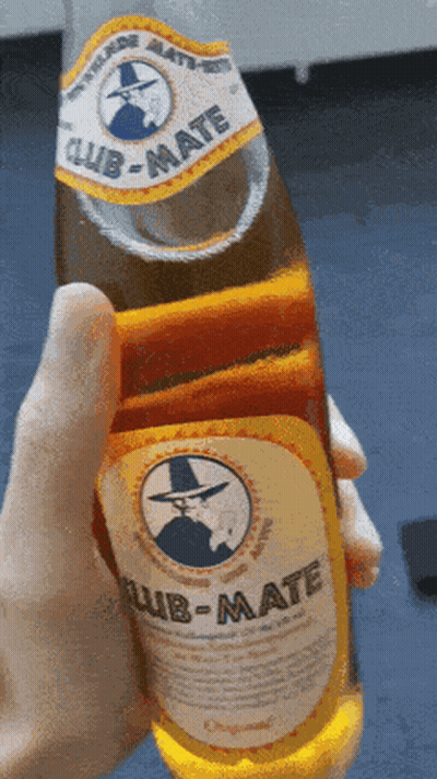 Someone Is Holding A Bottle Of Club-Mate In Their Hand GIF