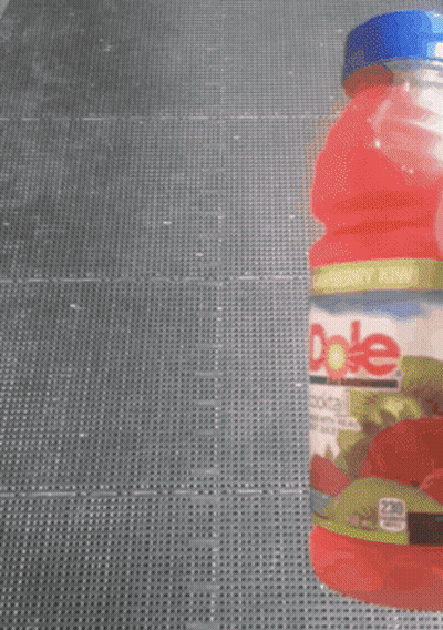 Someone Is Holding A Bottle Of Dole Strawberry Juice GIF